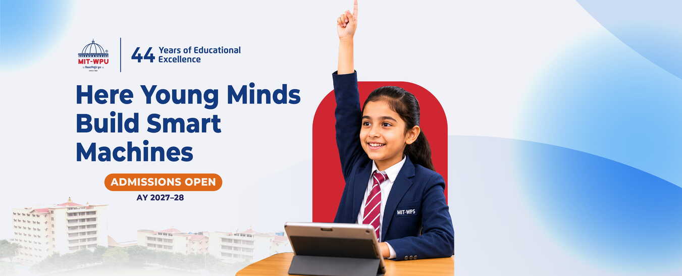 Student raising her hand next to a laptop at MIT World Peace School Alandi